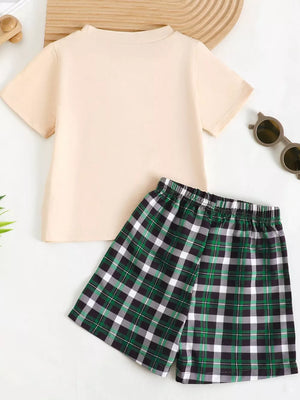 Baby set with a cream short sleeve tee and green plaid shorts.