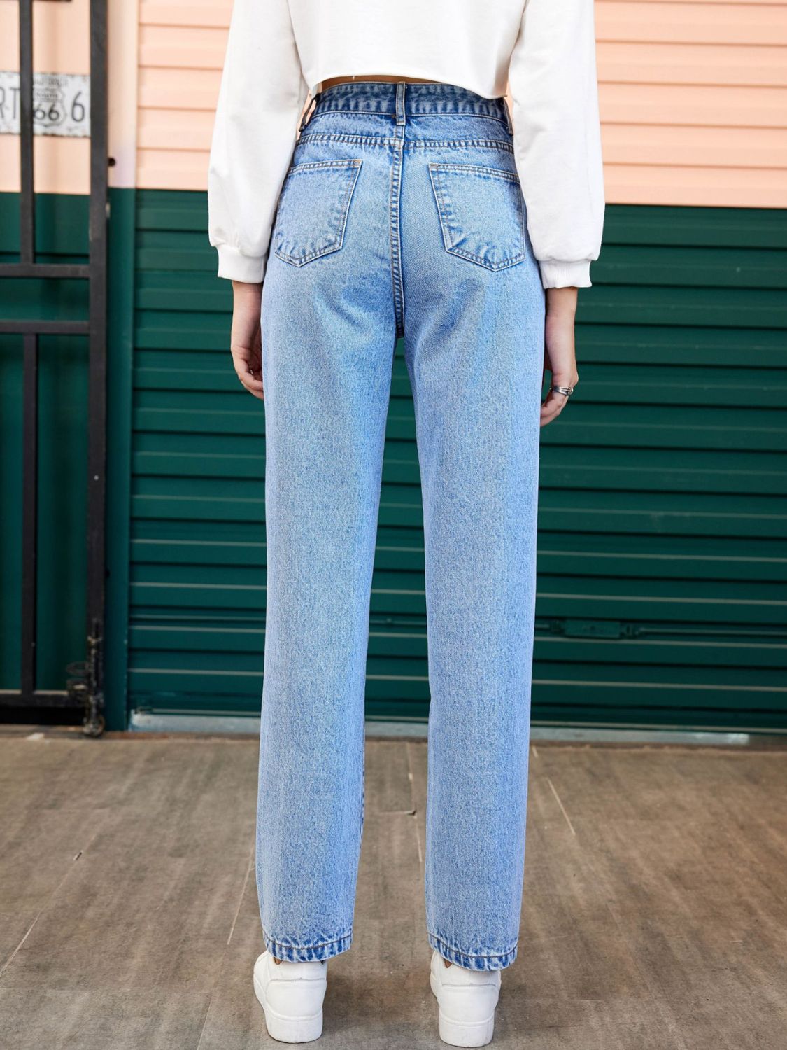 Light wash denim jeans with a straight leg cut and buttoned fly.