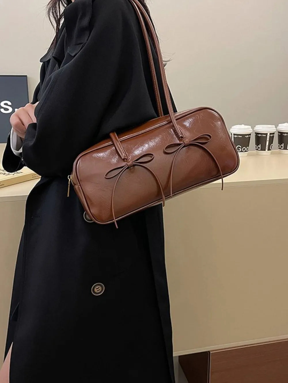 Brown patent leather shoulder bag with bow details