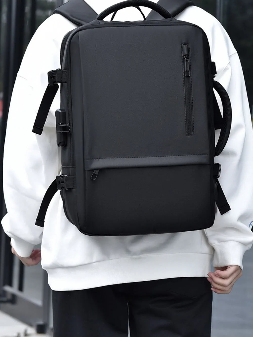 Black convertible commuter backpack with multiple zippers and side straps.