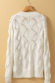 Openwork knit V-neck pullover in ivory acrylic with a wave pattern.