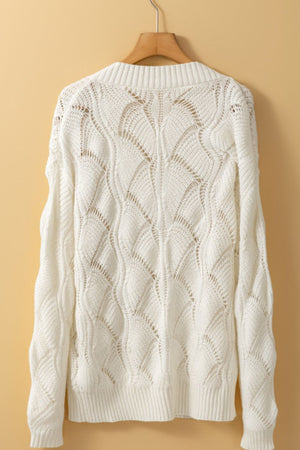 Openwork knit V-neck pullover in ivory acrylic with a wave pattern.