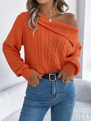 Chic off-shoulder cable knit sweater in pumpkin orange acrylic with a wide neckline.