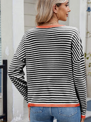 Black and white striped knit sweater with contrast trim and drop shoulder.