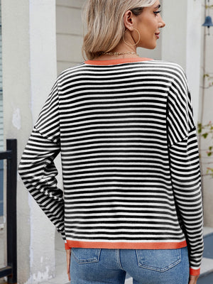 Black and white striped knit sweater with contrast trim and drop shoulder.