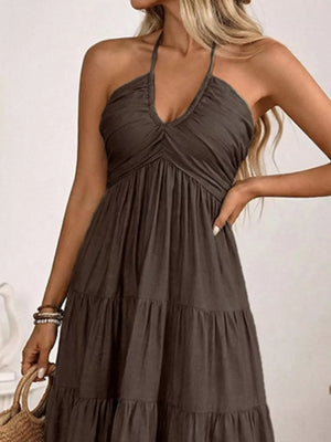 Dark brown smocked halter neck midi dress with tiered skirt.