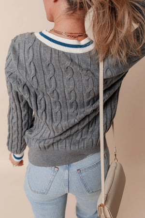 Dark gray cable knit sweater with varsity trim neckline and cuffs.