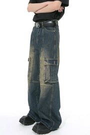 Dark wash distressed wide-leg cargo jeans with zippered pockets and a casual fit.