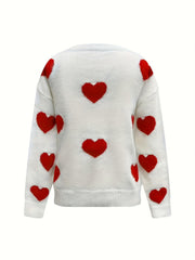 White oversized knit crewneck sweater with all-over red heart pattern and drop sleeves.