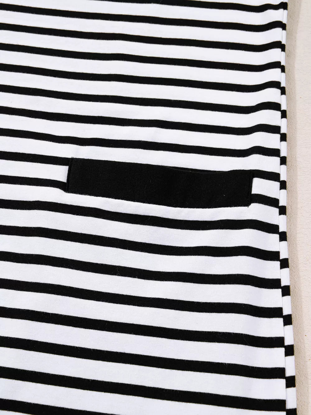 Black and white striped collared dress with a black pocket detail.