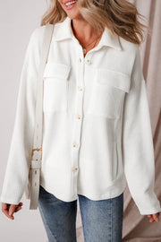 White textured corduroy overshirt with patch pockets and button front.