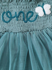 Sea blue smocked baby bodysuit with embroidered "one" and butterfly detail, and tulle skirt.