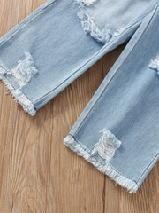 Toddler light wash denim jeans with distressed rips and frayed hems.