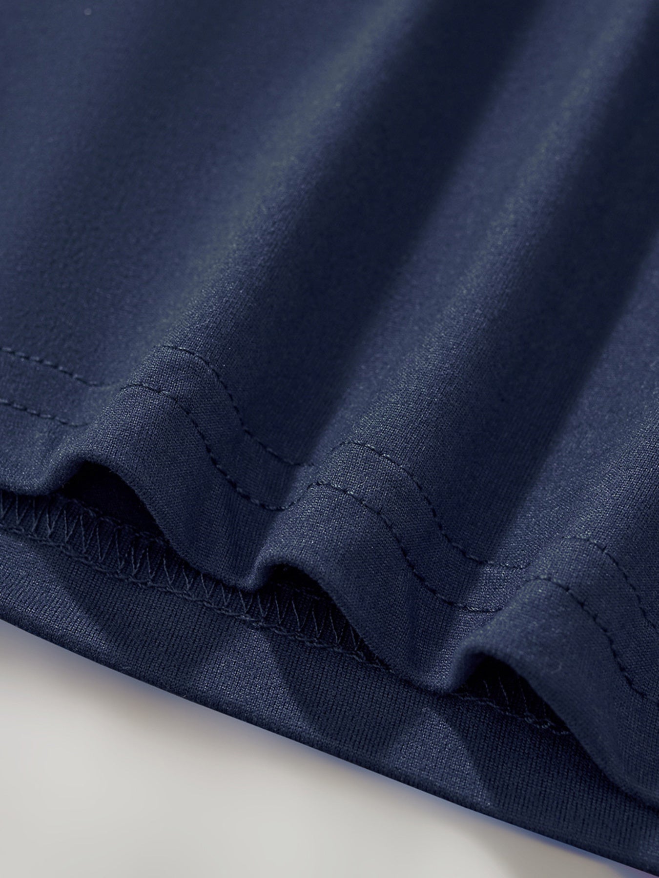 Navy blue toddler t-shirt detail showing hem stitching