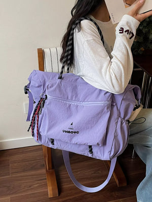 Lavender Oxford cloth travel duffel bag with front pockets and rope straps.