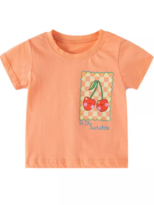 Toddler t-shirt in peach with a cheerful cherry graphic and "in the sunshine" text.