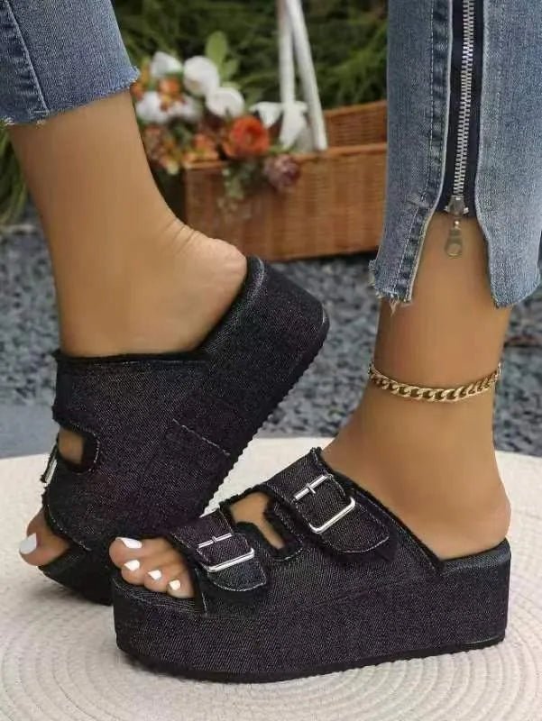 Denim platform slides with double buckle straps in black, featuring a thick sole and open toe.