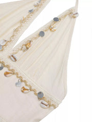 Bohemian halter maxi dress in apricot with seashell and sequin trim.