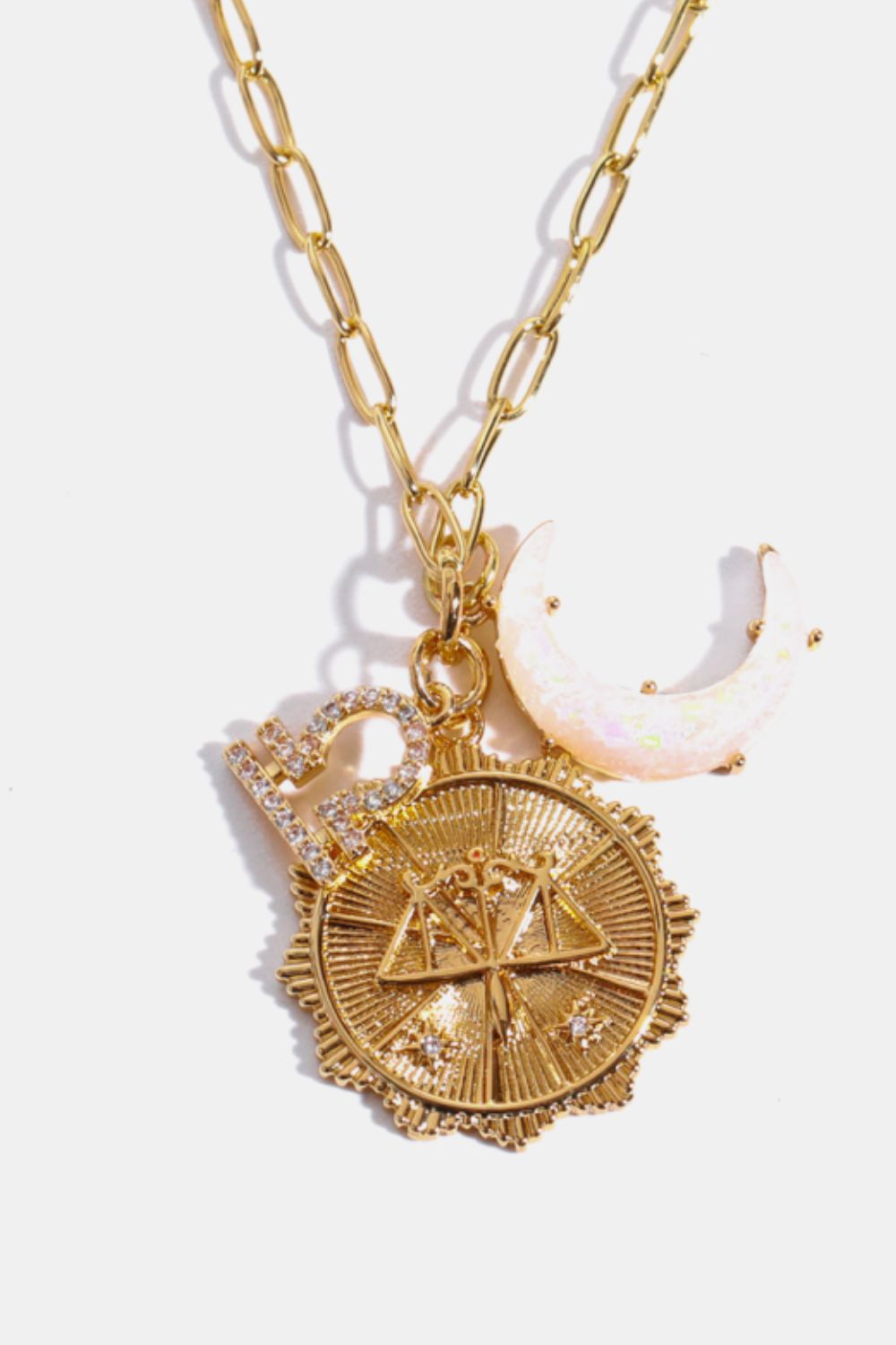 Gold Libra zodiac pendant necklace with celestial charms and moon detail.