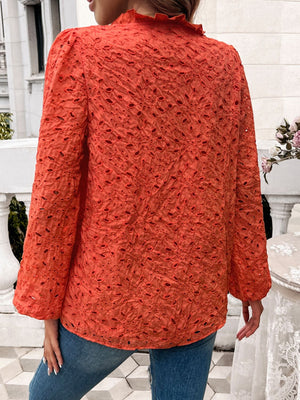 Orange-red eyelet embroidered blouse with ruffle collar and puff sleeves.