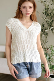 Textured knit v-neck shell top in beige with cap sleeves.