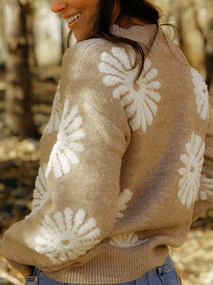 Tan knit sweater with textured floral motifs, crew neck, long sleeves, and ribbed cuffs and hem.