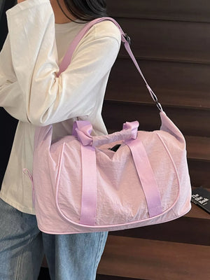 Lightweight purple Oxford cloth duffel bag with pink straps and handles.