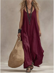 Burgundy scoop neck maxi dress with spaghetti straps, flowing skirt, and layered necklaces.