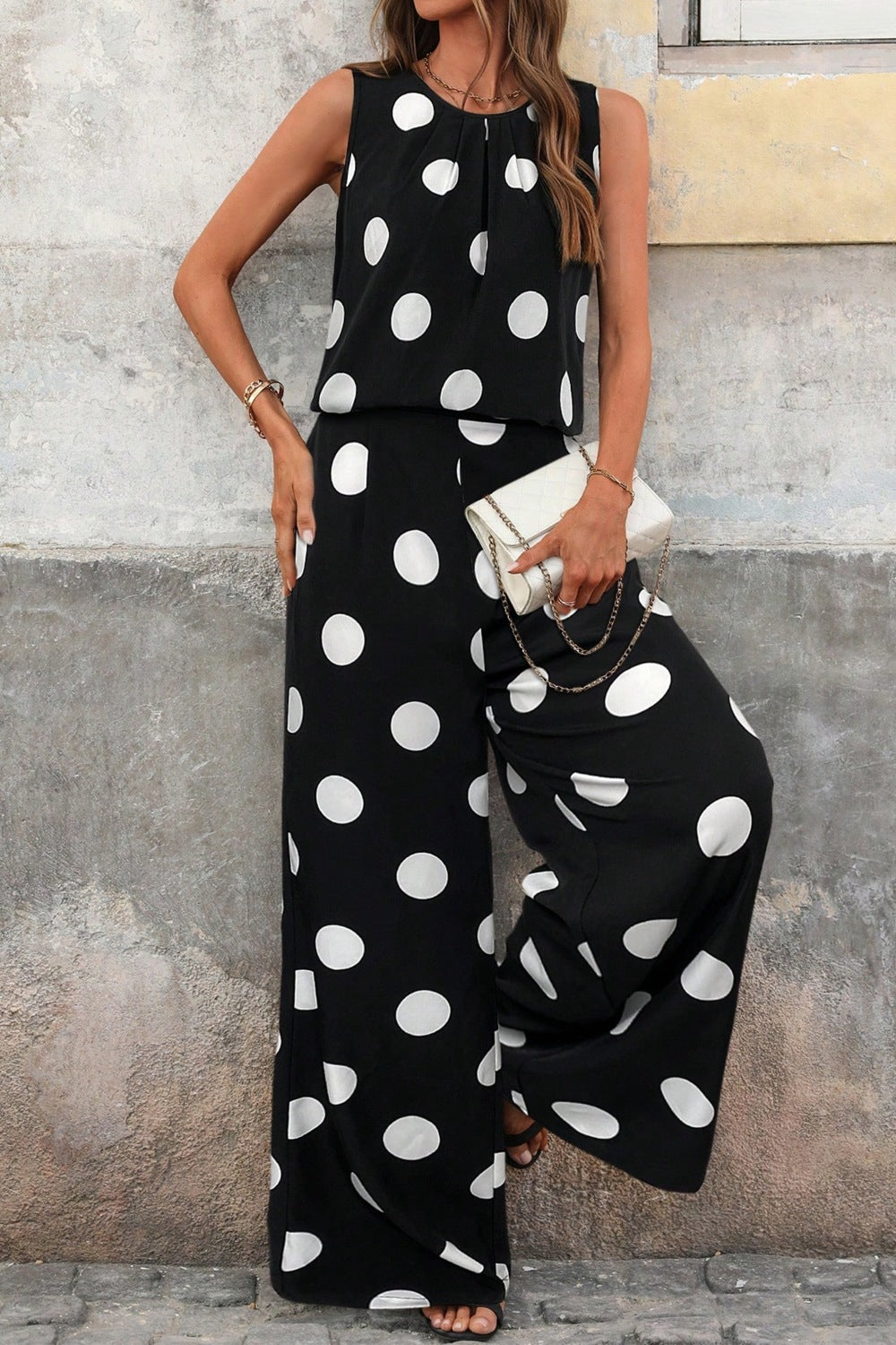 Black polka dot two-piece set with wide-leg pants and sleeveless top.