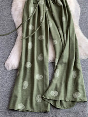 Green paisley print drawstring maternity joggers with wide legs.