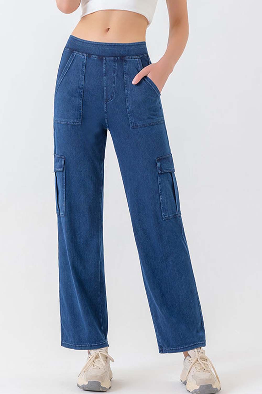 Utility denim cargo pants in dark blue with multiple pockets and a relaxed fit.