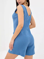 Blue crinkled cotton sleeveless button-down romper with pockets