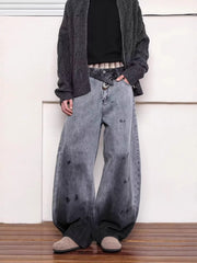 Men's washed wide leg jeans with distressed details and a gradient fade.