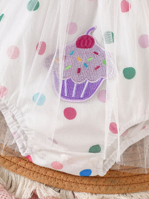 White baby bodysuit dress with polka dots and cupcake applique detail.