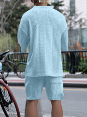 Sky blue cable-knit two-piece set with short sleeves and shorts.