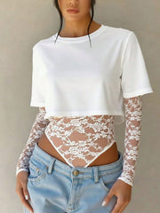 White lace bodysuit with sheer long sleeves and patchwork detail.