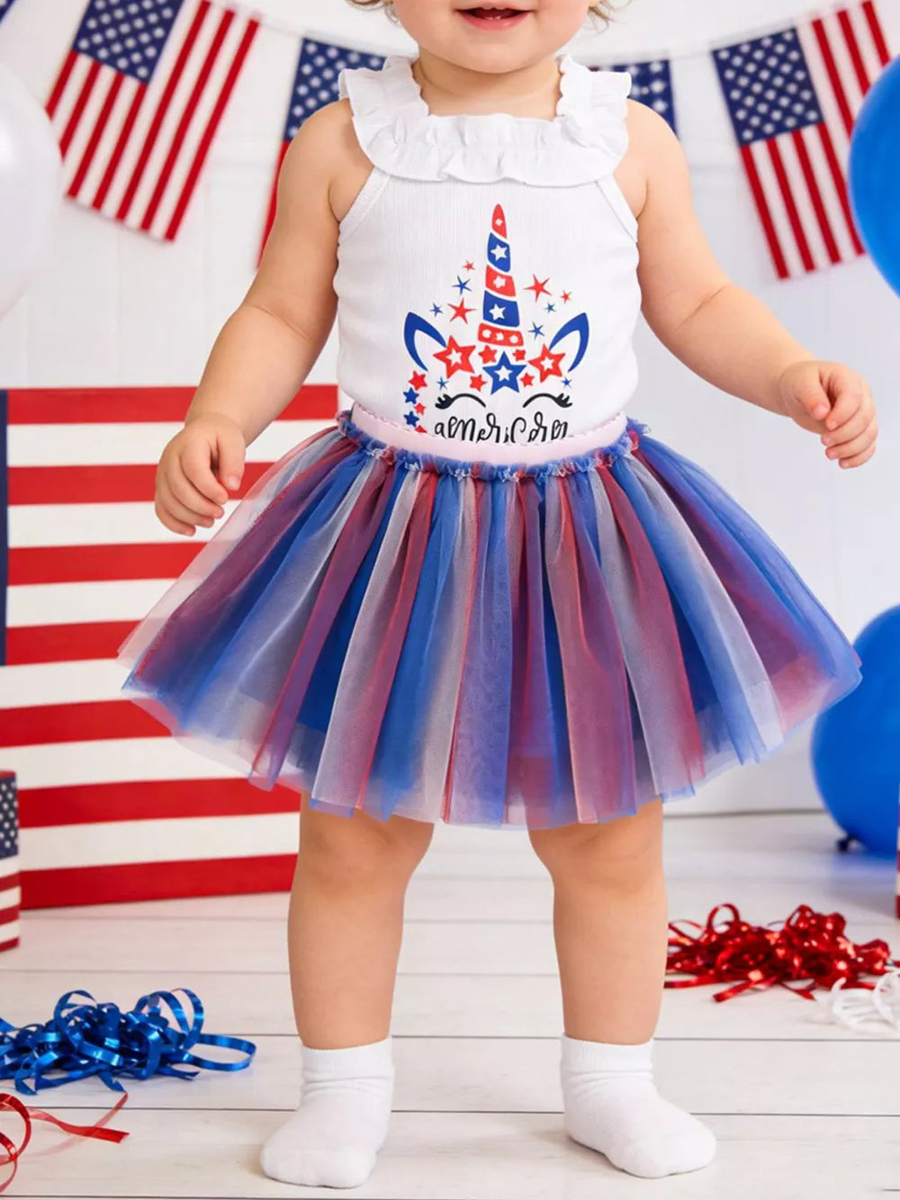 Baby tutu dress with unicorn graphic and red, white, blue tulle skirt.