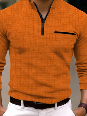 Orange textured zip-neck polo shirt with contrast black pocket detail.