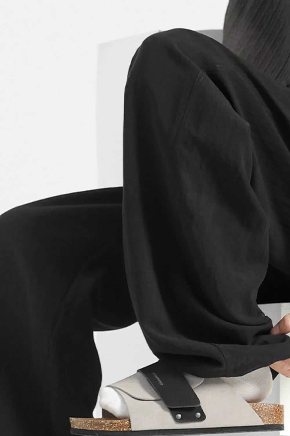 Black wide-leg lounge sweatpants with a relaxed fit and casual styling.