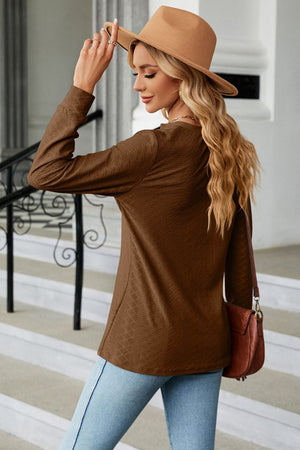 Brown textured henley blouse with button detail and long sleeves.