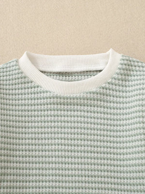 Baby knit set in light green waffle texture with white ribbed crew neck.