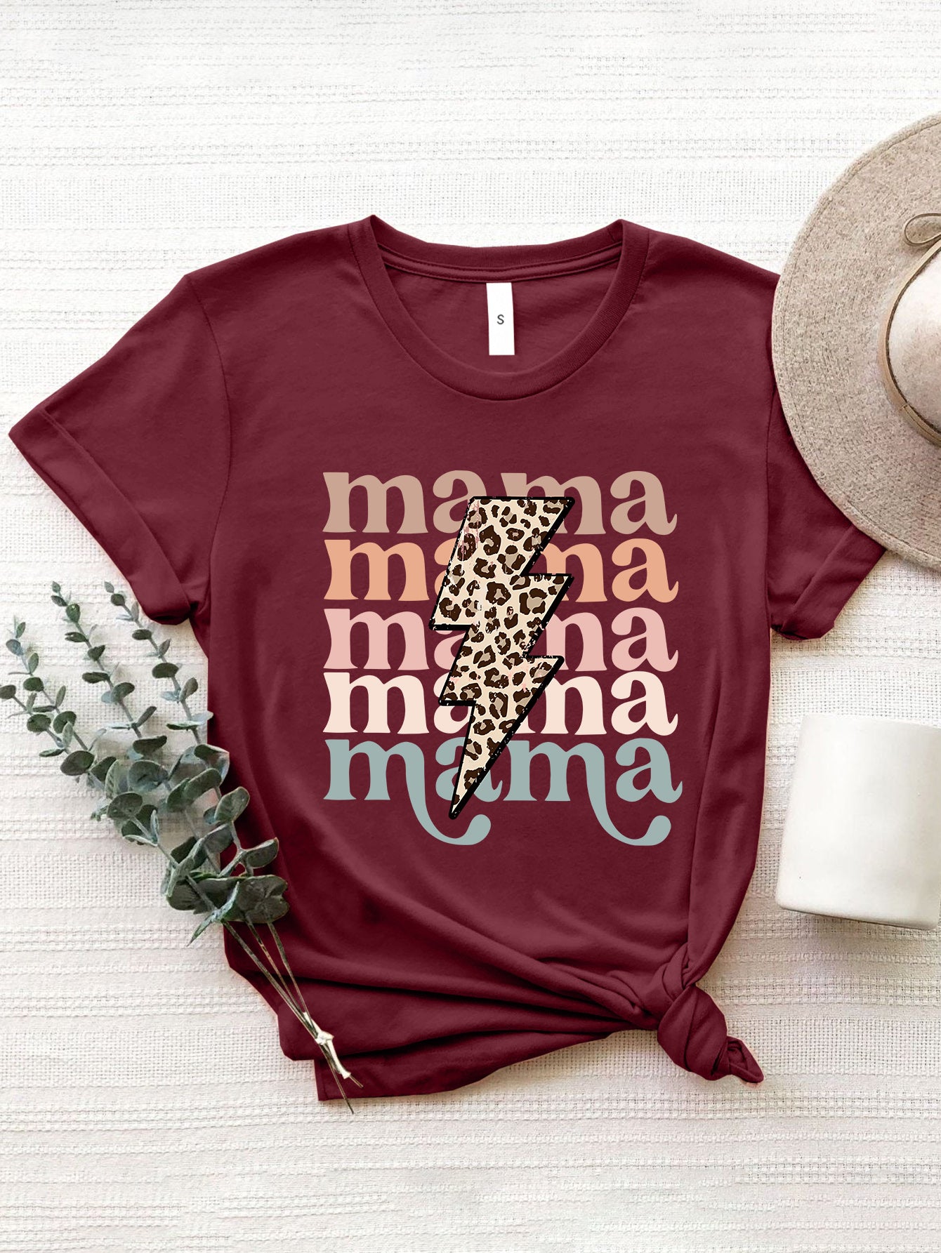 Burgundy Mama Bolt graphic t-shirt with leopard print lightning bolt and colorful text.
