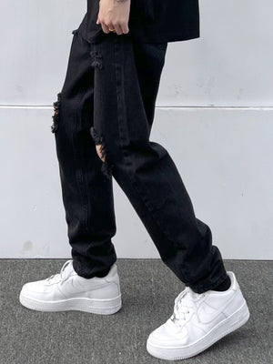Black distressed slim fit 100 cotton jeans with ripped details.