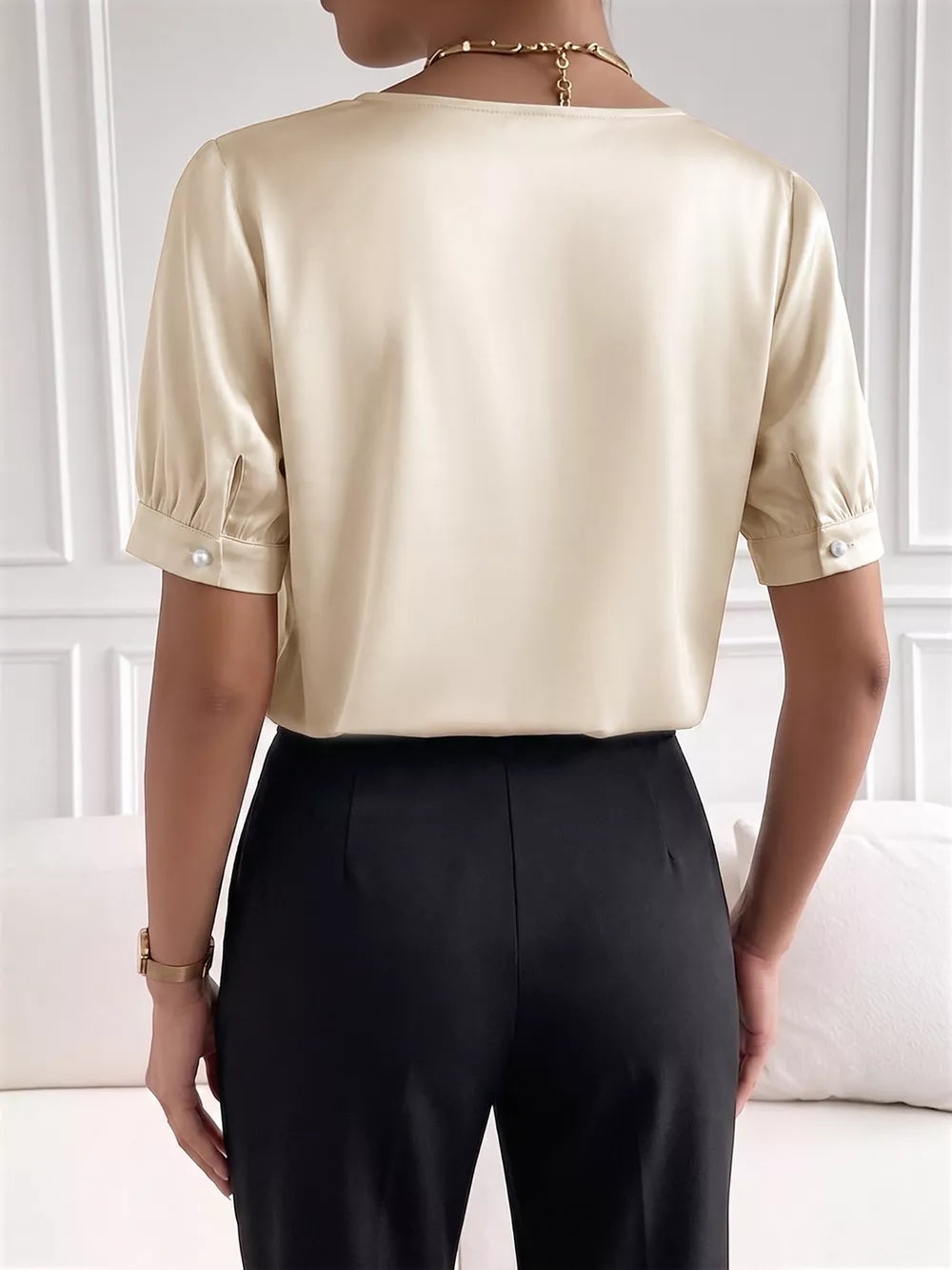 Pearl-trimmed satin bodysuit with short sleeves and a V-neckline.
