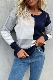 Geometric panel knit sweater in navy, white, and gray with a crew neck and long sleeves.