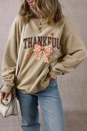 Khaki graphic sweatshirt with "Thankful" text and a leopard print bow detail.