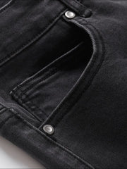 Black wash denim jeans with split hem detail and button closure.