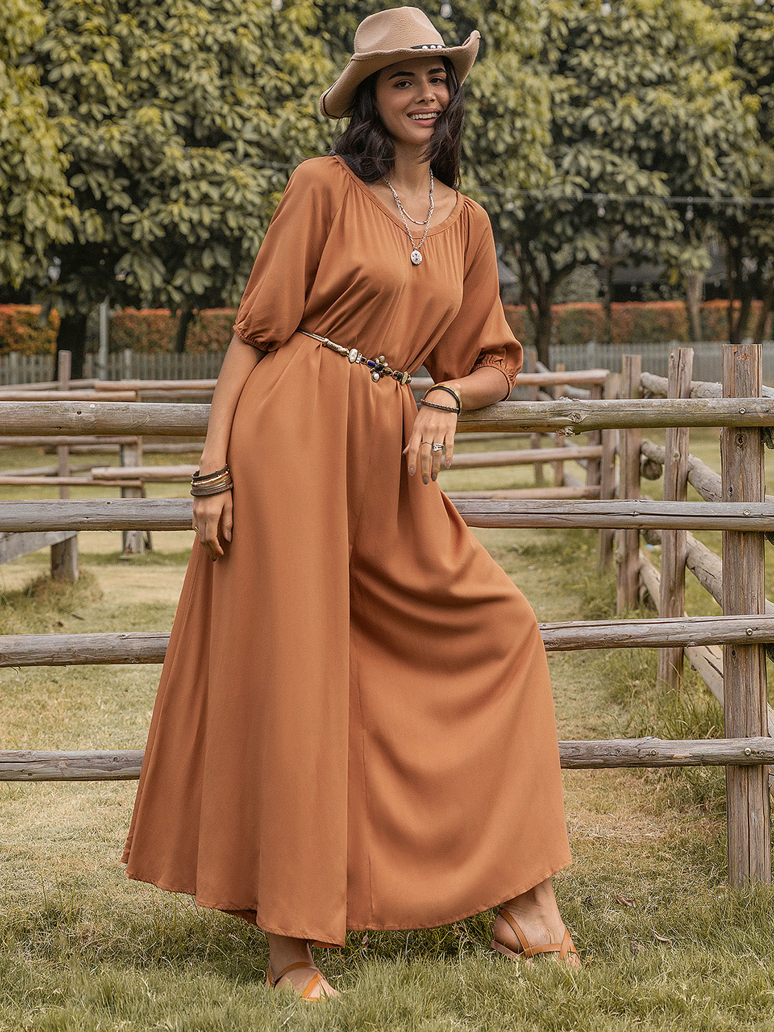Caramel gathered sleeve wide-leg jumpsuit with a cinched waist and buttoned neckline.