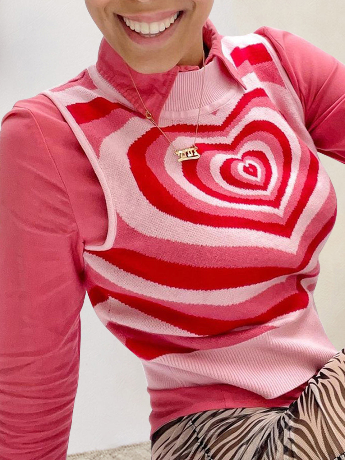 Pink knit tank top with concentric heart intarsia pattern in red and pink stripes.