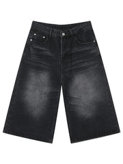 Wide-leg denim culotte shorts in washed black with buttoned fly and front pockets.